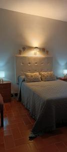 a bedroom with a bed and a light on the wall at Casería El Albercón in Mancha Real +45 photos