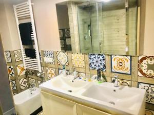 a bathroom with a sink and a mirror and a tub at CASA Di ANNA 2 in Terracina +3 photos