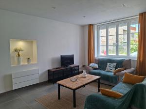 a living room with a couch and a table at Maison de campagne - Granges sur Lot in Granges-sur-Lot
