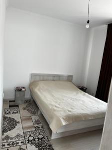 a bedroom with a bed in a white room at Diamond Resort Cottage Issyk-Kul in Bosteri