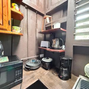 a kitchen with appliances on a wooden counter top at La Cabaña de Don Tavo in Roble +11 photos