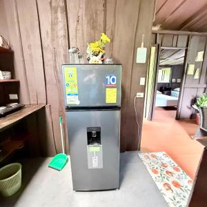a small refrigerator sitting inside of a room at La Cabaña de Don Tavo in Roble