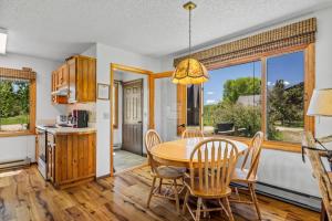 a kitchen and dining room with a table and chairs at Chipmunk in Clark