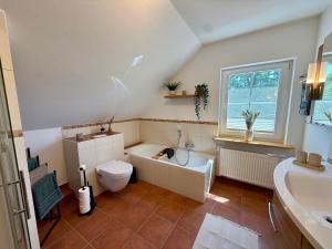 a bathroom with a tub and a toilet and a sink at Haus Muhblick in Schmallenberg +33 photos