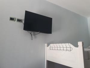 a flat screen tv hanging on a white wall at First American Inn in Borsh