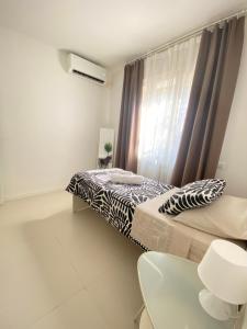 a bedroom with a bed and a window at Urban Suite- Holiday Rooms in Padova +11 photos