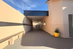 a hallway of a building with a plant in a yellow pot at Completa e próxima ao Acqualinda in Andradina