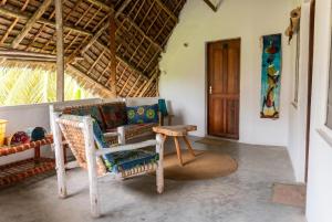 a living room with a couch and a chair at Villa Kiota in Paje