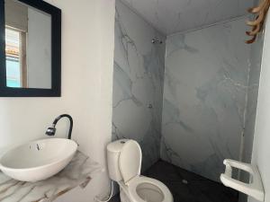 a bathroom with a sink and a toilet and a mirror at AcapulcoBeach in Playa Blanca +48 photos