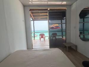 a bedroom with a bed and a view of the ocean at AcapulcoBeach in Playa Blanca