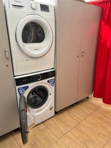 a washing machine and a washer in a kitchen at ARBERs aparthotel in Durrës