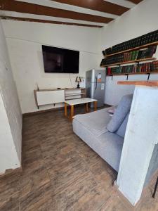 a living room with a couch and a tv at La Chiquitita apart in San Fernando del Valle de Catamarca