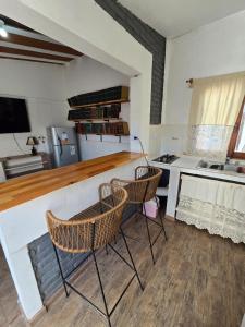 a kitchen with two chairs and a counter top at La Chiquitita apart in San Fernando del Valle de Catamarca