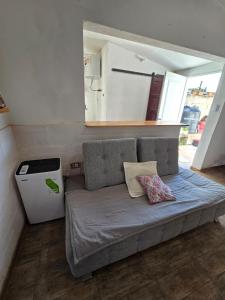 a couch in a room with a trash can at La Chiquitita apart in San Fernando del Valle de Catamarca