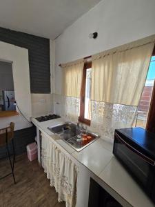 a kitchen with a sink and a counter top at La Chiquitita apart in San Fernando del Valle de Catamarca +18 photos