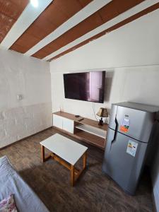 a living room with a refrigerator and a table at La Chiquitita apart in San Fernando del Valle de Catamarca