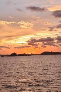 a sunset over a large body of water at Amazing Grace Panamá in Boca Chica
