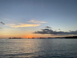 a sunset over a large body of water at Amazing Grace Panamá in Boca Chica