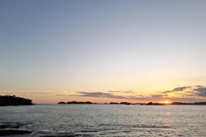 a sunset over a large body of water at Amazing Grace Panamá in Boca Chica +5 photos