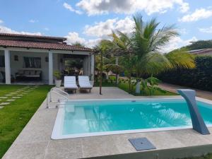 a swimming pool in the backyard of a house at Summer House in Jijoca de Jericoacoara