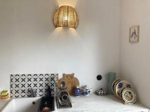 a kitchen with a sink and a light on the wall at Good Chata Leśna Polana in Dobry Las