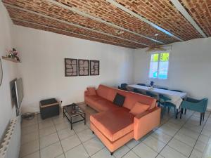 a living room with a couch and a table at La Clé des Vignes 3 in Roye