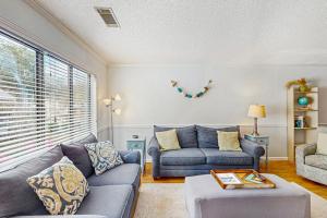 a living room with two couches and a table at Springwood Villas 51 in Hilton Head Island