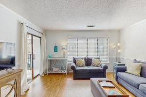 a living room with a couch and a tv at Springwood Villas 51 in Hilton Head Island
