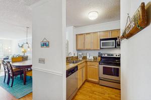 a kitchen with wooden cabinets and a kitchen with a table at Springwood Villas 51 in Hilton Head Island +16 photos