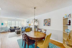 a dining room and living room with a table and chairs at Springwood Villas 51 in Hilton Head Island