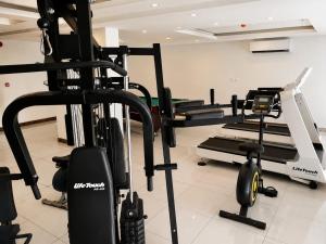 a gym with several tread machines in a room at Elaf Al Sharqyah Hotel -Alaziziah فندق ايلاف الشرقية العزيزية in Al Khobar