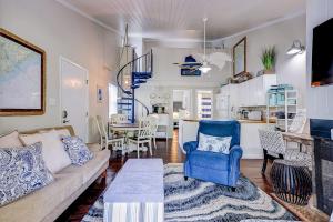 a living room with a couch and a table at Driftwood Villa - 269 in Edisto Island