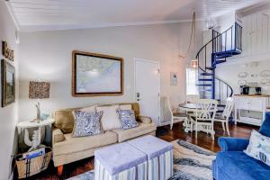 a living room with a couch and a table at Driftwood Villa - 269 in Edisto Island