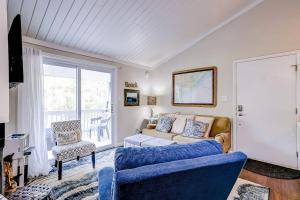 a living room with a couch and a chair at Driftwood Villa - 269 in Edisto Island