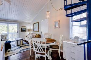 a kitchen and dining room with a table and chairs at Driftwood Villa - 269 in Edisto Island +26 photos