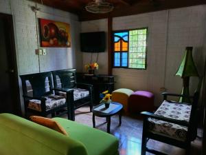 a living room with furniture and a stained glass window at Cabaña Bamel in San Antero