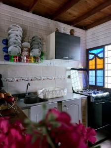 a kitchen with a sink and a stove top oven at Cabaña Bamel in San Antero +13 photos