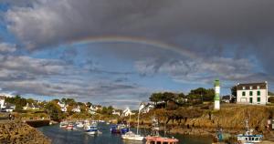 a rainbow over a group of boats in a harbor at Ti Bleunv-nevez in Moëlan-sur-Mer