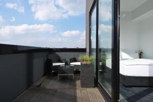 a balcony with a bedroom and a bed at LINDEMANN'S in Berlin