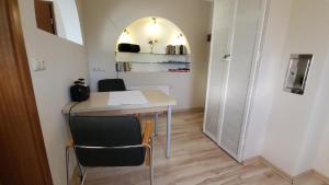a small room with a desk and two chairs at Ferienwohnung Erika in Usedom Town +6 photos