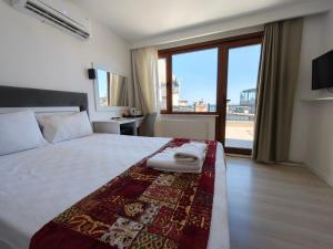 a bedroom with a bed and a large window at Grand Peninsula Hotel in Istanbul