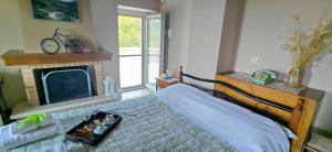 a bedroom with a bed with a tv and a bed sidx sidx sidx at Arxontiko Taygeti in Mystras