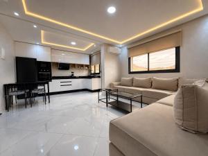 a living room with a couch and a table at Royal Rif Alhoceima in Al Hoceïma