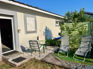 a group of chairs sitting outside of a house at Chez Christelle in Audenge