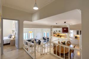 a living room and dining room with a kitchen and a living room at Syros Private House with superb sea view in Kini