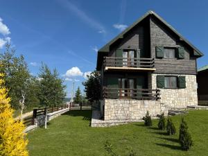 a house on a hill with a green yard at Wolf Chalet in Motički Gaj +12 photos