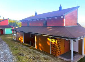 a red barn with two large garage doors at miki Chalets in Pack