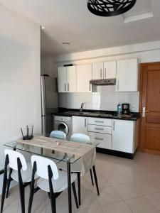 a kitchen with a table and chairs in a room at Peaceful Home in Cabo Negro