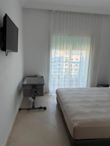 a bedroom with a bed and a flat screen tv at Peaceful Home in Cabo Negro