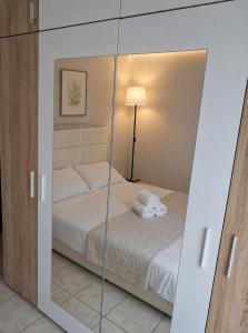 a mirror in a bedroom with a bed at Epanomi apartment in Epanomi